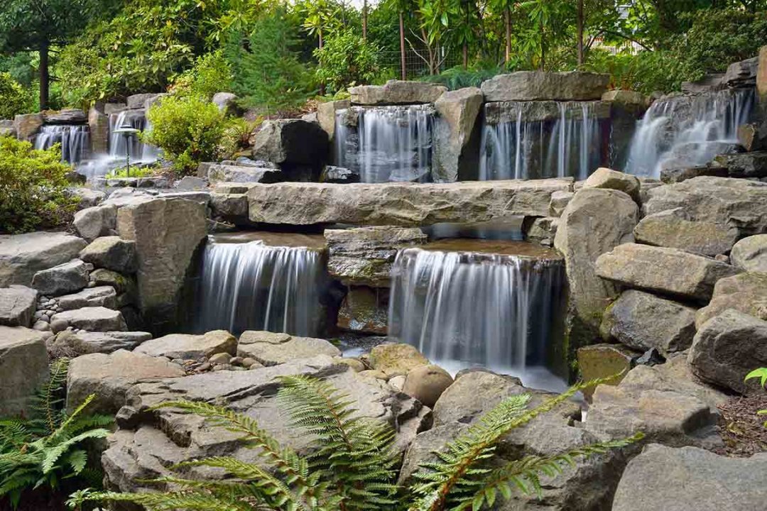 Stunning waterfall water feature with boulders - 7 Dees Landscaping Large manmade waterfall with natural boulders - 7 Dees Landscaping