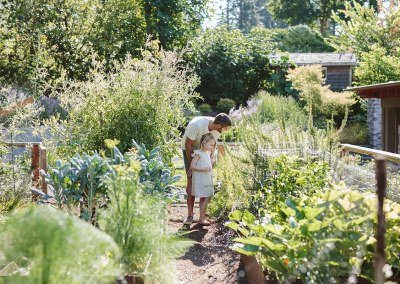 father and daughter in vegetable garden
