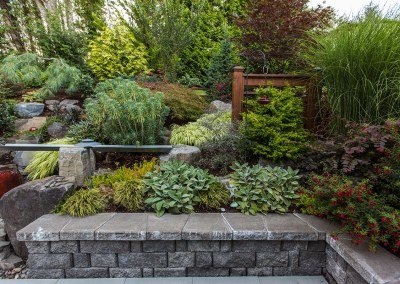 A Hardscaped retaining wall with plants by Dennis' 7 Dees