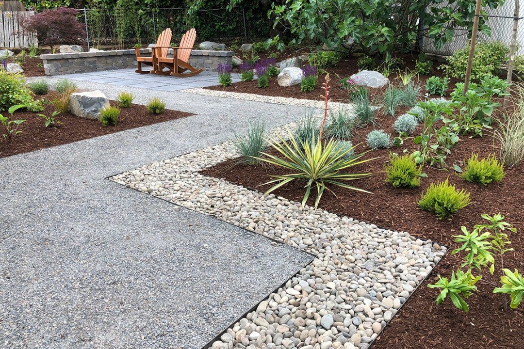 Waterwise landscape with edged gravel path - 7 Dees Landscaping Mulch beds, stone edging, and gravel walkway in backyard by - 7 Dees Landscaping