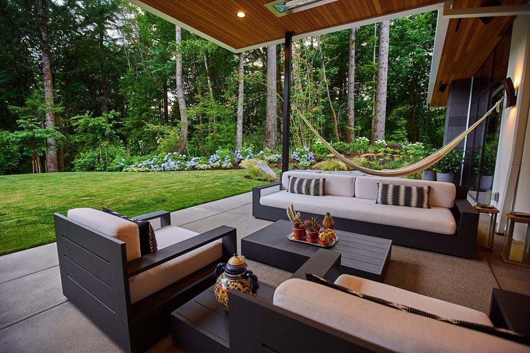 Seating area with hammock and large lawn and hydrangeas in distance - 7 Dees Landscaping