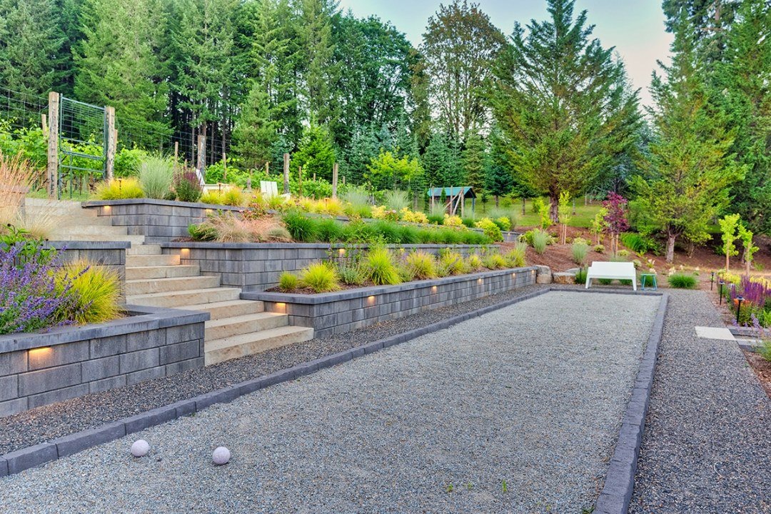 Bocce ball court and planted retaining wall in residential landscape by 7 Dees Landscaping
