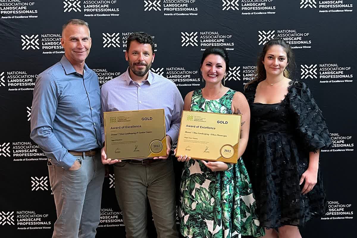 Dennis' 7 Dees NALP Awards 2022 - 4 people holding 2 gold award plaques