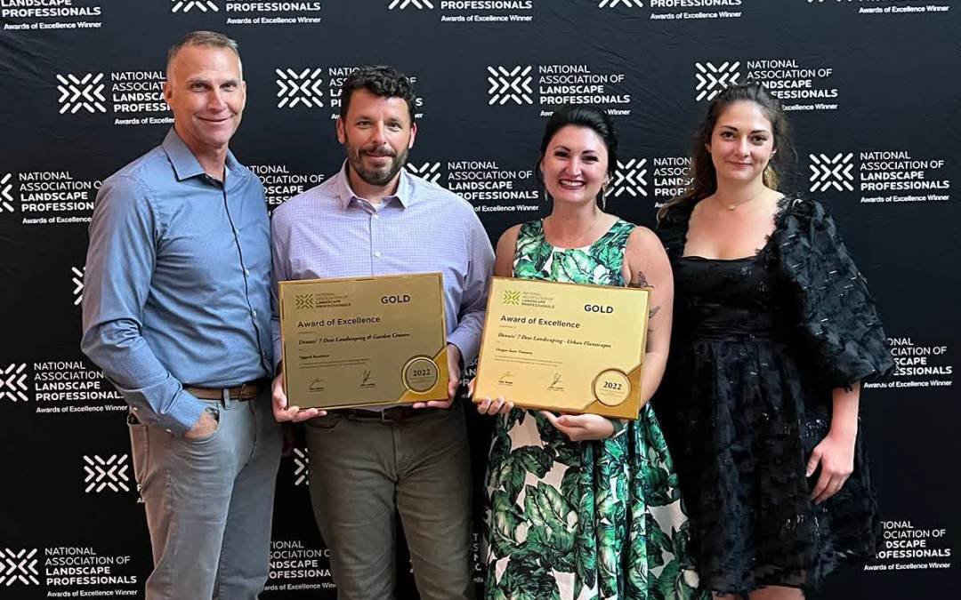 Dennis' 7 Dees NALP Awards 2022 - 4 people holding 2 gold award plaques