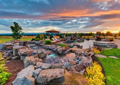 Natural waterfall spillway water feature in residential landscape by Dennis' 7 Dees