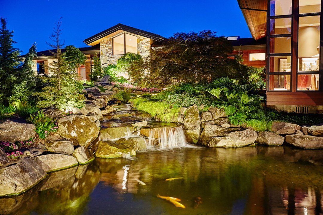 Natural stone trickling waterfall water feature and koi pond by Dennis' 7 Dees Landscaping Natural stone trickling waterfall water feature and koi pond by Dennis' 7 Dees Landscaping