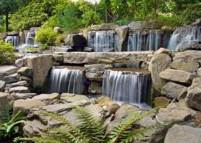 Large-scale waterfall water feature designed and installed by Dennis' 7 Dees Landscaping