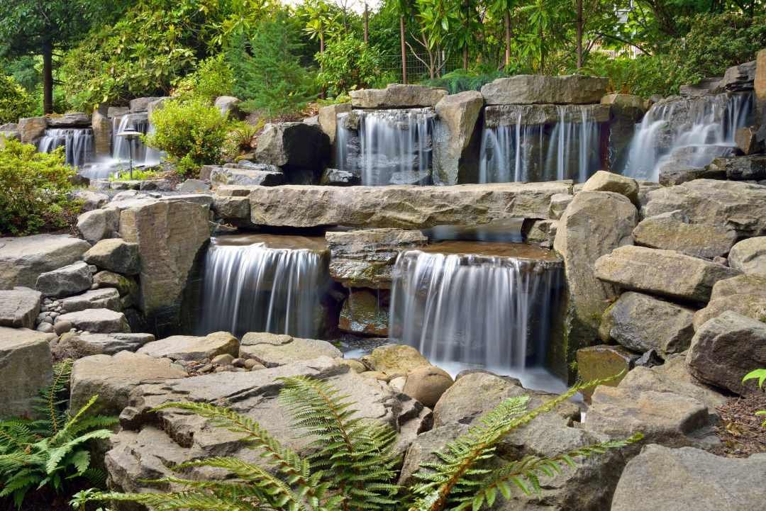 Large-scale waterfall water feature designed and installed by Dennis' 7 Dees Landscaping Large-scale waterfall water feature designed and installed by Dennis' 7 Dees Landscaping