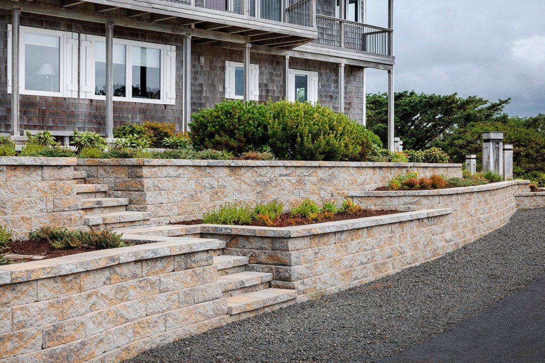 Warm stone retaining wall with steps and planter beds along Oregon coast - 7 Dees Landscaping