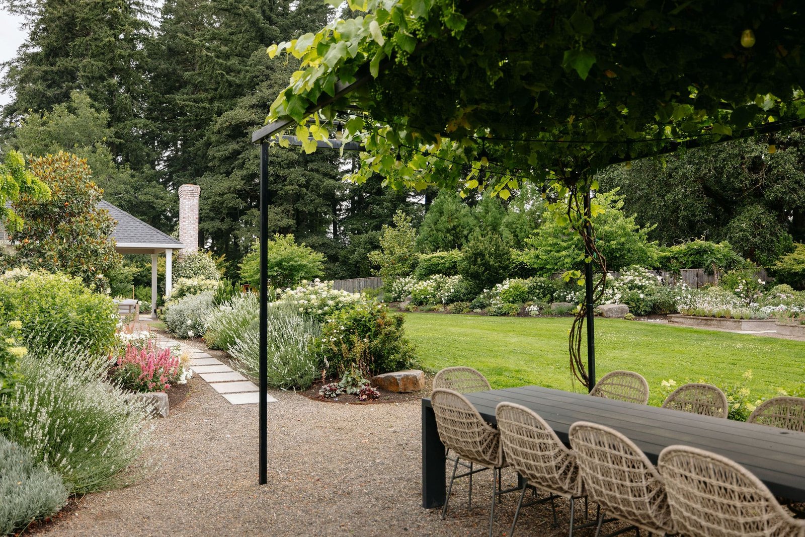 Mediterranean style landscape with pathway and outdoor dining